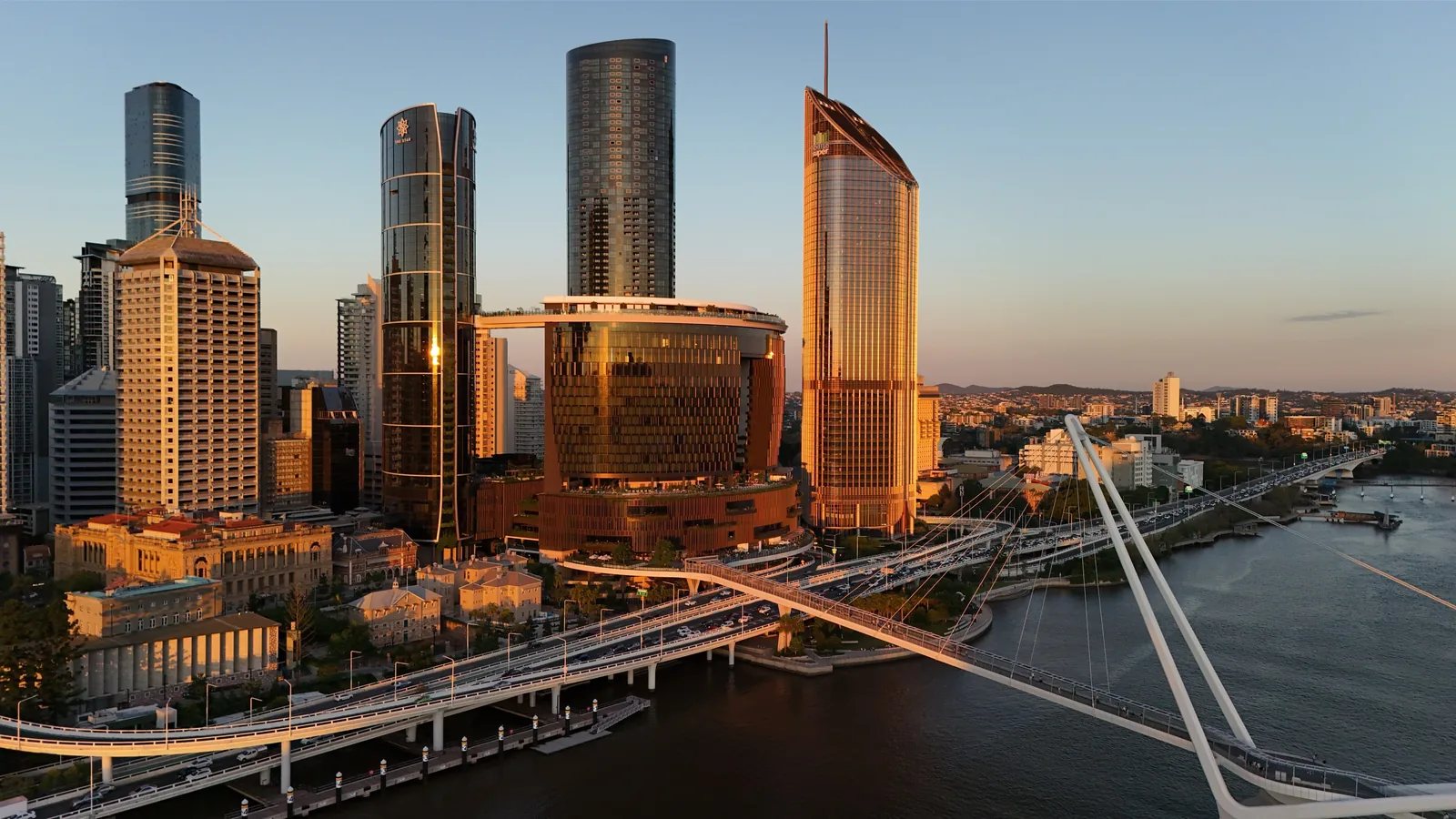 Brisbane city skyline at golden hour along the river