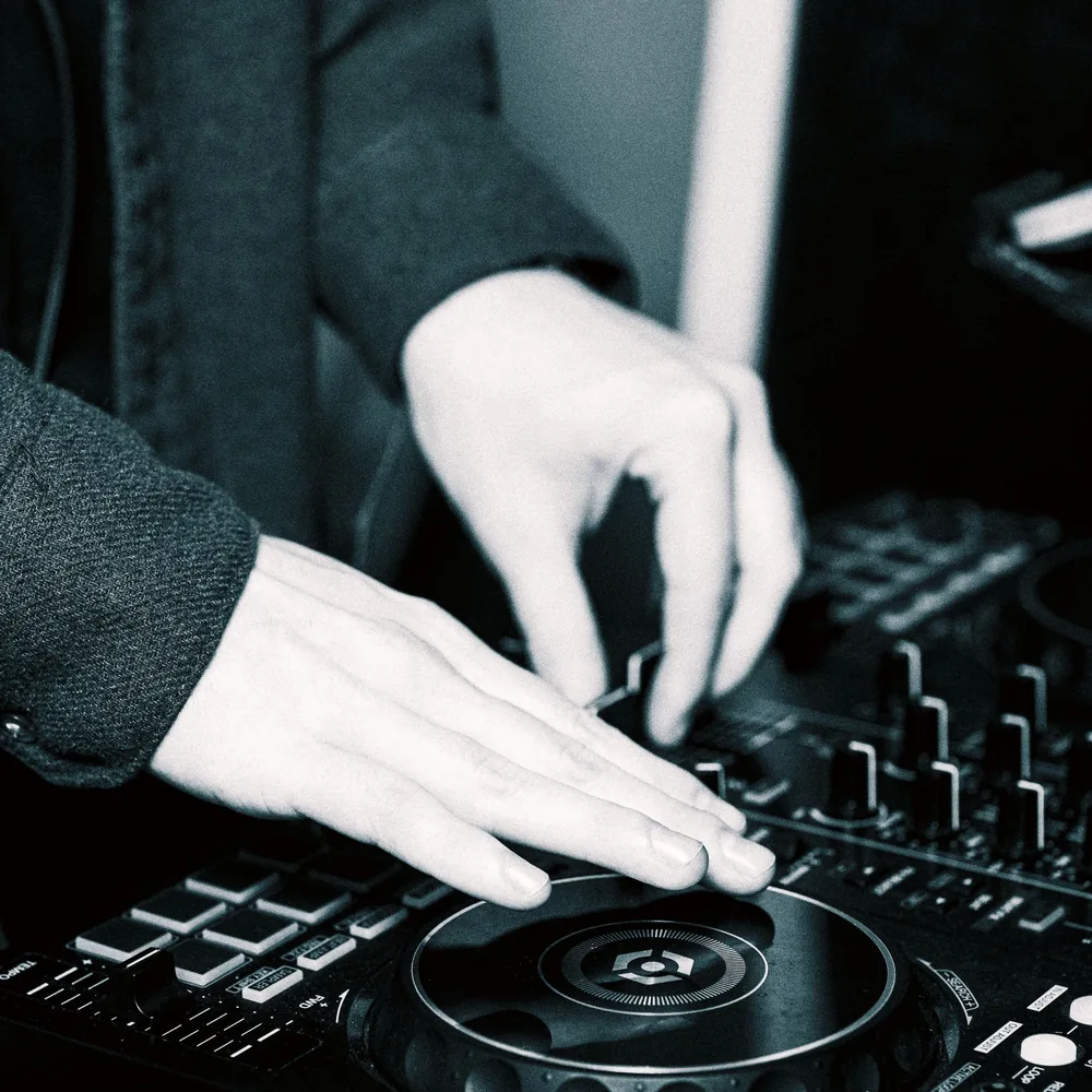 Close-up of hands mixing on a professional DJ controller